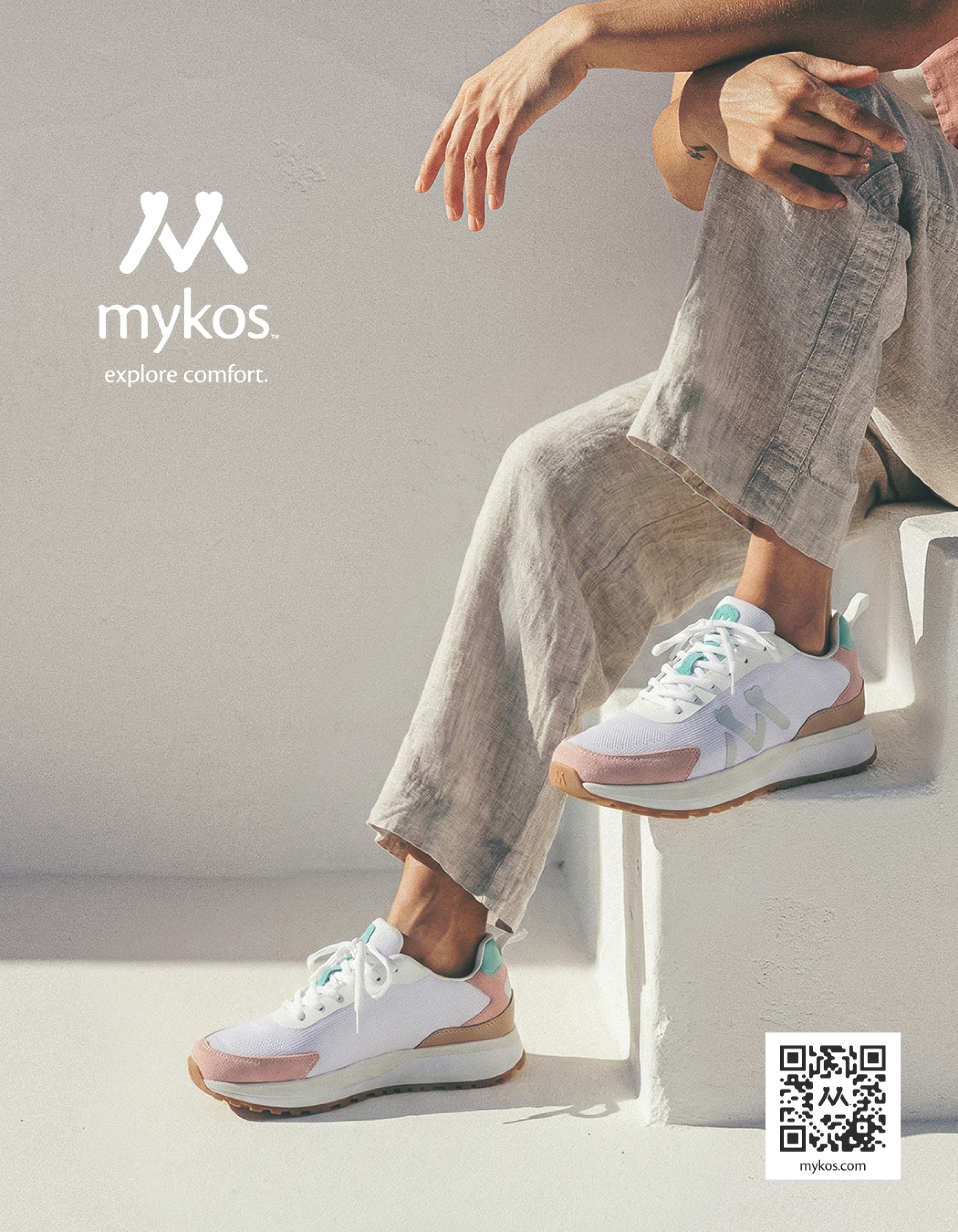 A pair of white sneakers with pink shoelaces. Description generated by AI